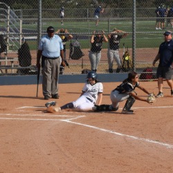 The softball team in action - a player slides into home base.
